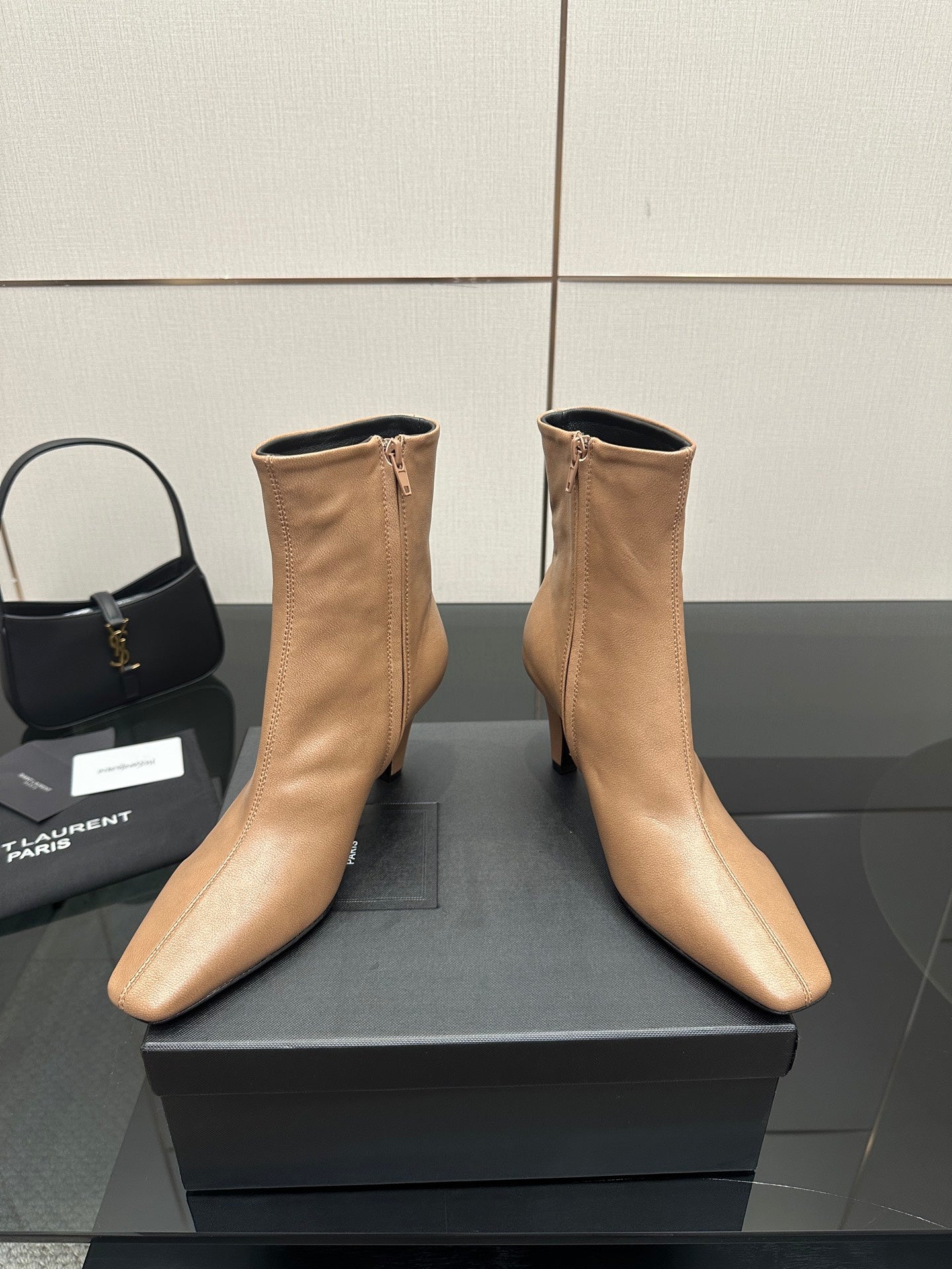 Beige ankle boots with pointed toe, slim high heel, zipper detail on box