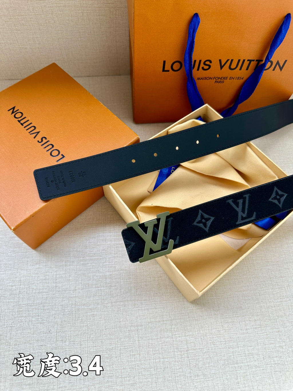 Louis Vuitton belt top view, dark navy monogram strap with silver buckle.