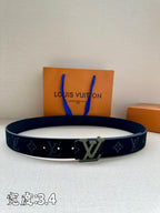 Louis Vuitton belt, dark navy with monogram pattern and silver LV buckle.