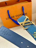 Blue Louis Vuitton belt with gold-tone LV buckle and dark blue leather strap with holes.