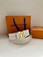 Louis Vuitton belt with pastel blue patterned strap and gold LV buckle on box.