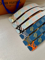 Two patterned canvas belts with gold-tone LV buckles, light blue and dark blue geometric straps