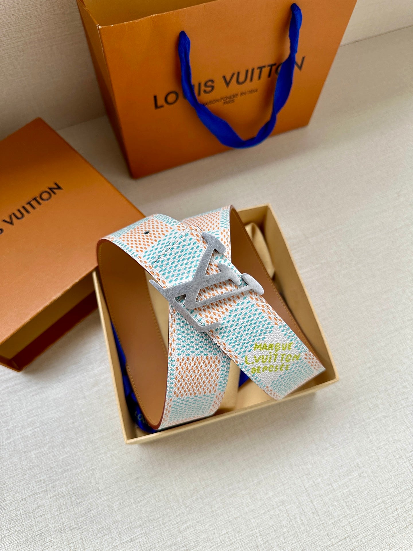 Patterned canvas belt with gold-tone LV buckle, light blue and multicolor geometric strap