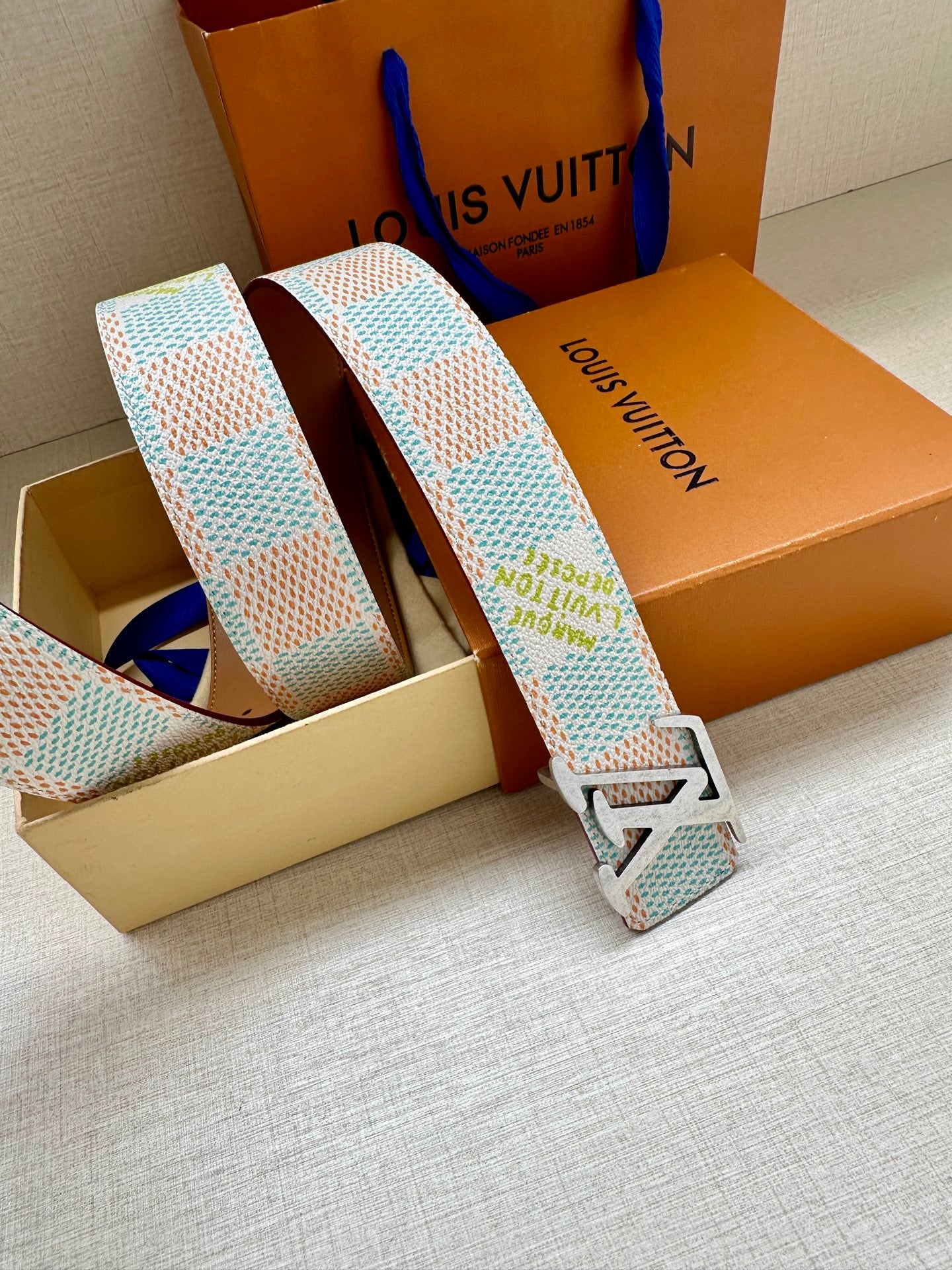 Patterned canvas belt with gold-tone buckle, light blue and multicolor geometric weave