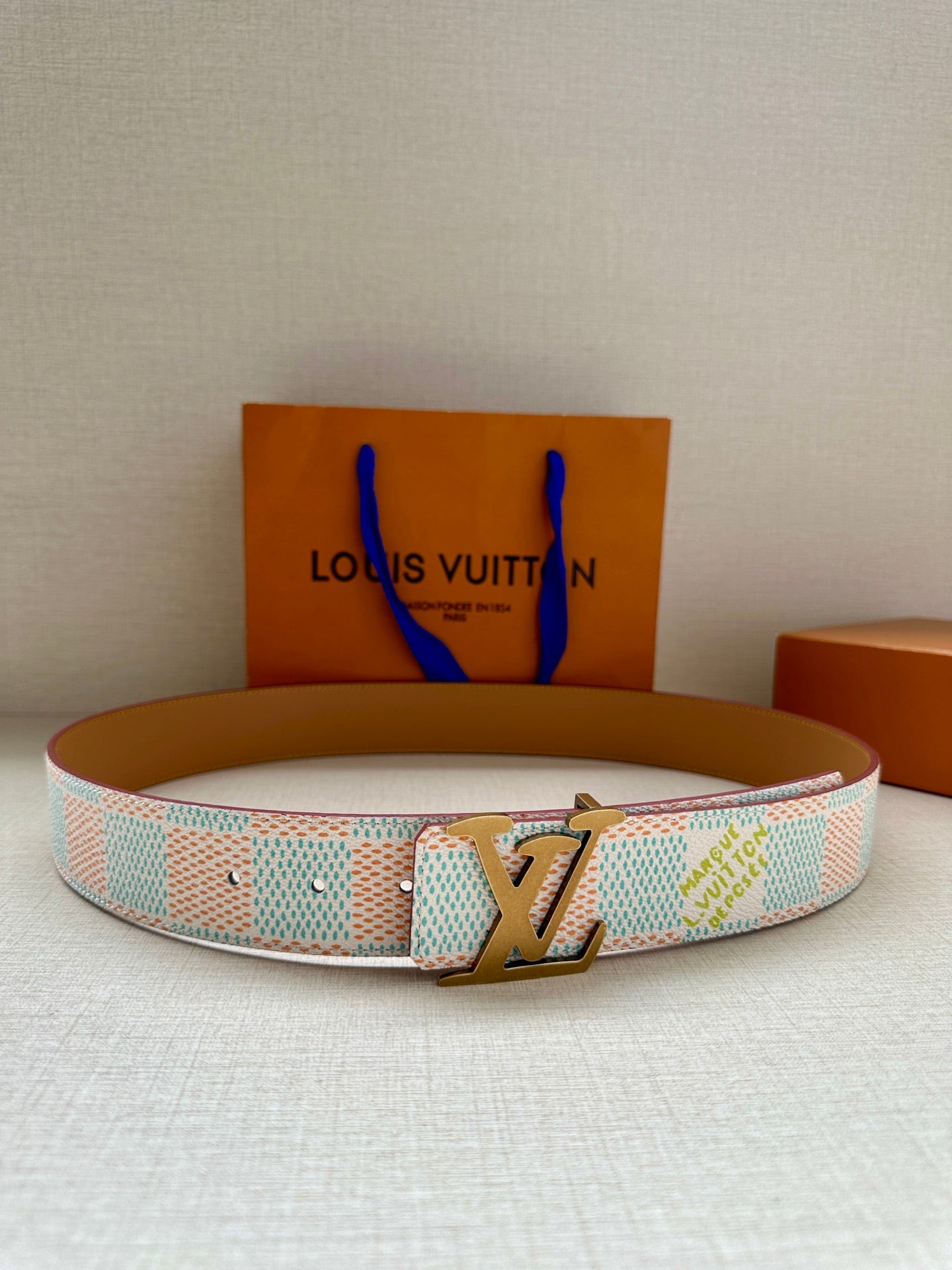Patterned canvas belt with gold-tone LV buckle, light blue and cream checker design