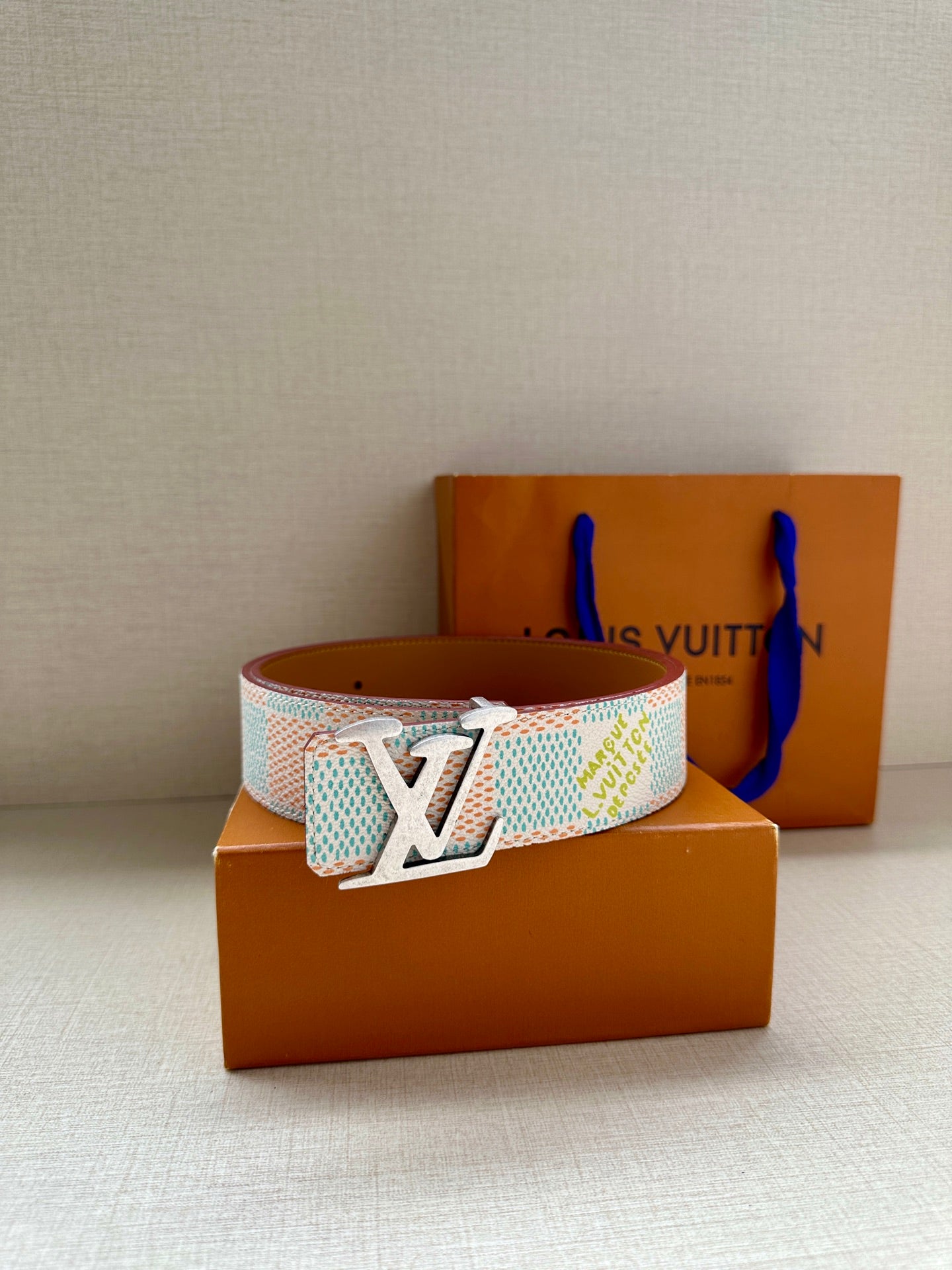 Patterned canvas belt with gold-tone LV buckle, light blue and cream geometric woven strap