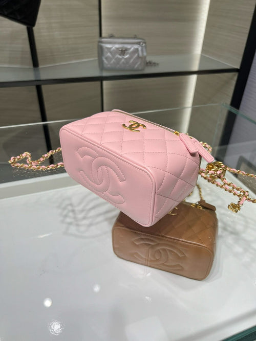 Pink quilted Chanel mini bag with gold chain strap and front logo
