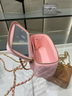 Pink Chanel mini bag open view with quilted leather interior and gold zipper