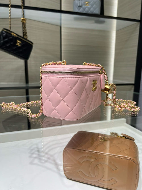Pink quilted Chanel crossbody bag with gold chain and zippered front pocket