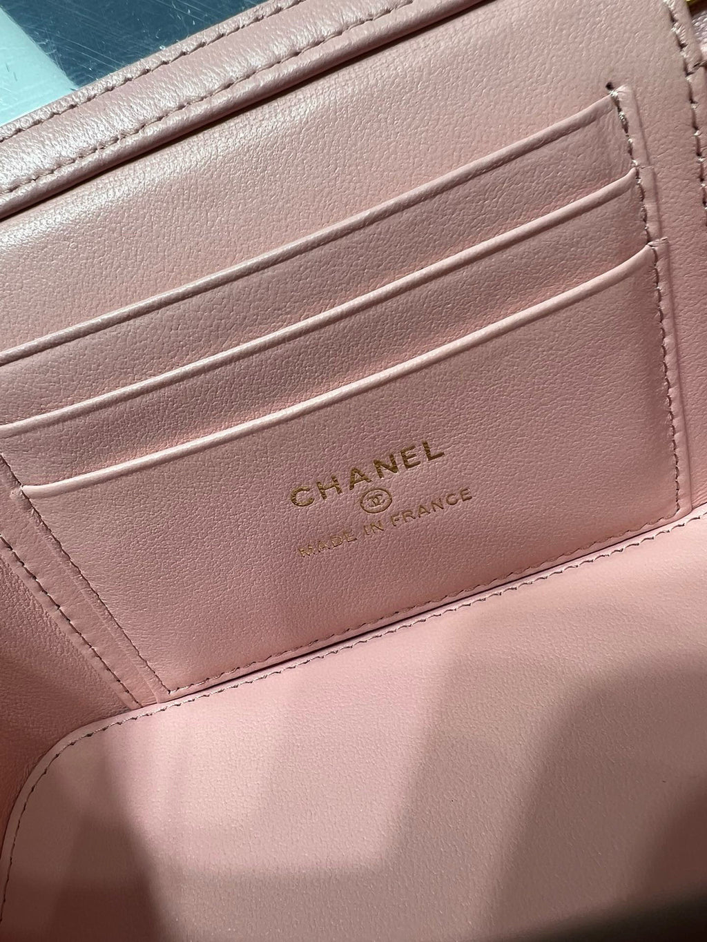 Pink Chanel bag interior with embossed card slot and CHANEL branding