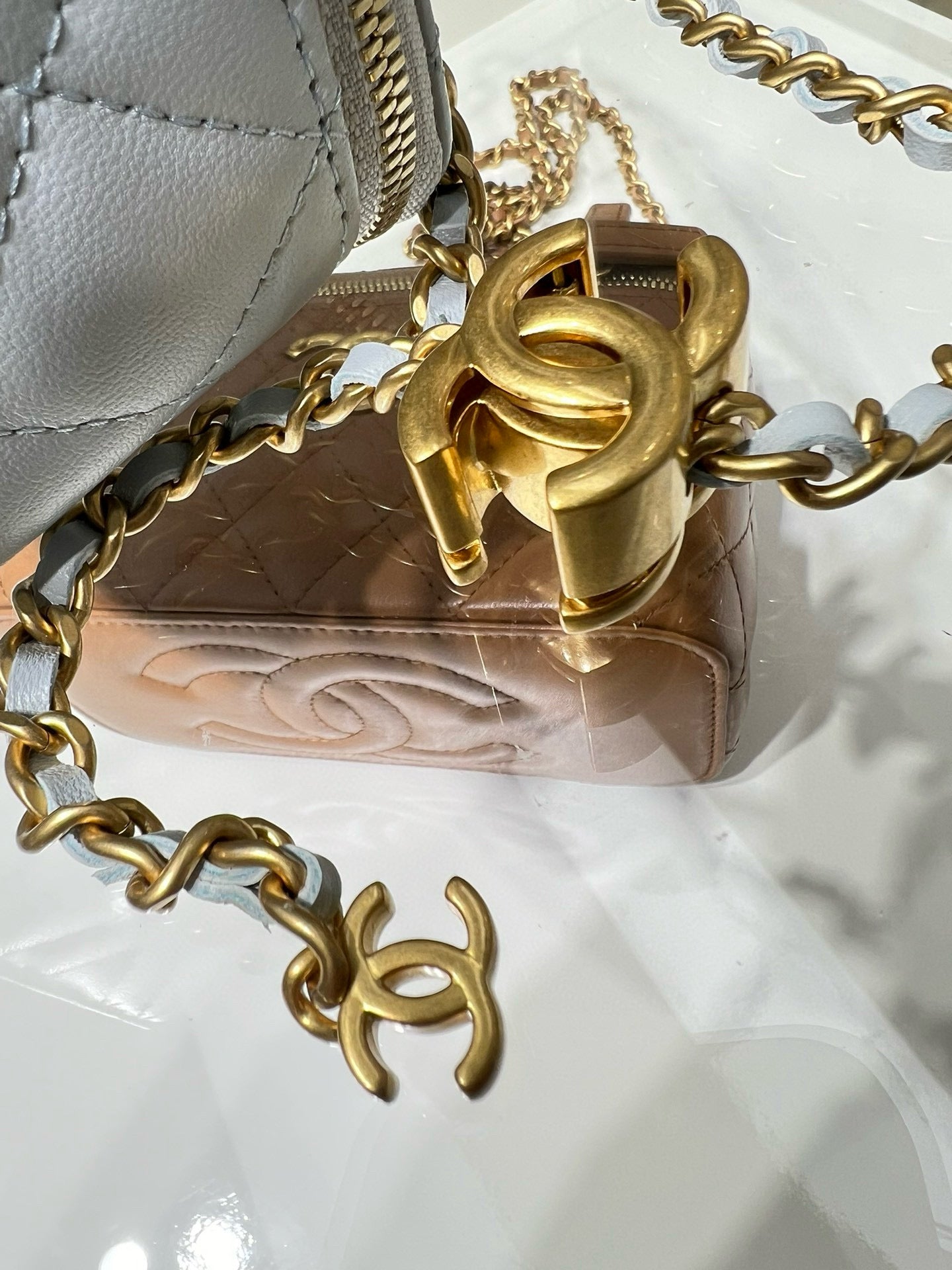Gold-tone clasp and chain hardware on light blue Chanel bag