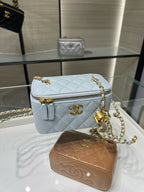 Light blue Chanel crossbody bag with diamond quilting, gold-tone logo and zipper pull