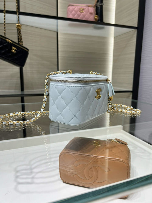 Light blue quilted Chanel bag with gold chain strap and top zipper