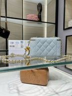 Light blue quilted crossbody bag with gold-tone chain and front logo charm