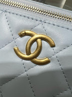 Gold interlocking logo on light blue quilted leather with zipper trim