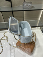 Light blue mini handbag with open top showing fabric lining and zipper