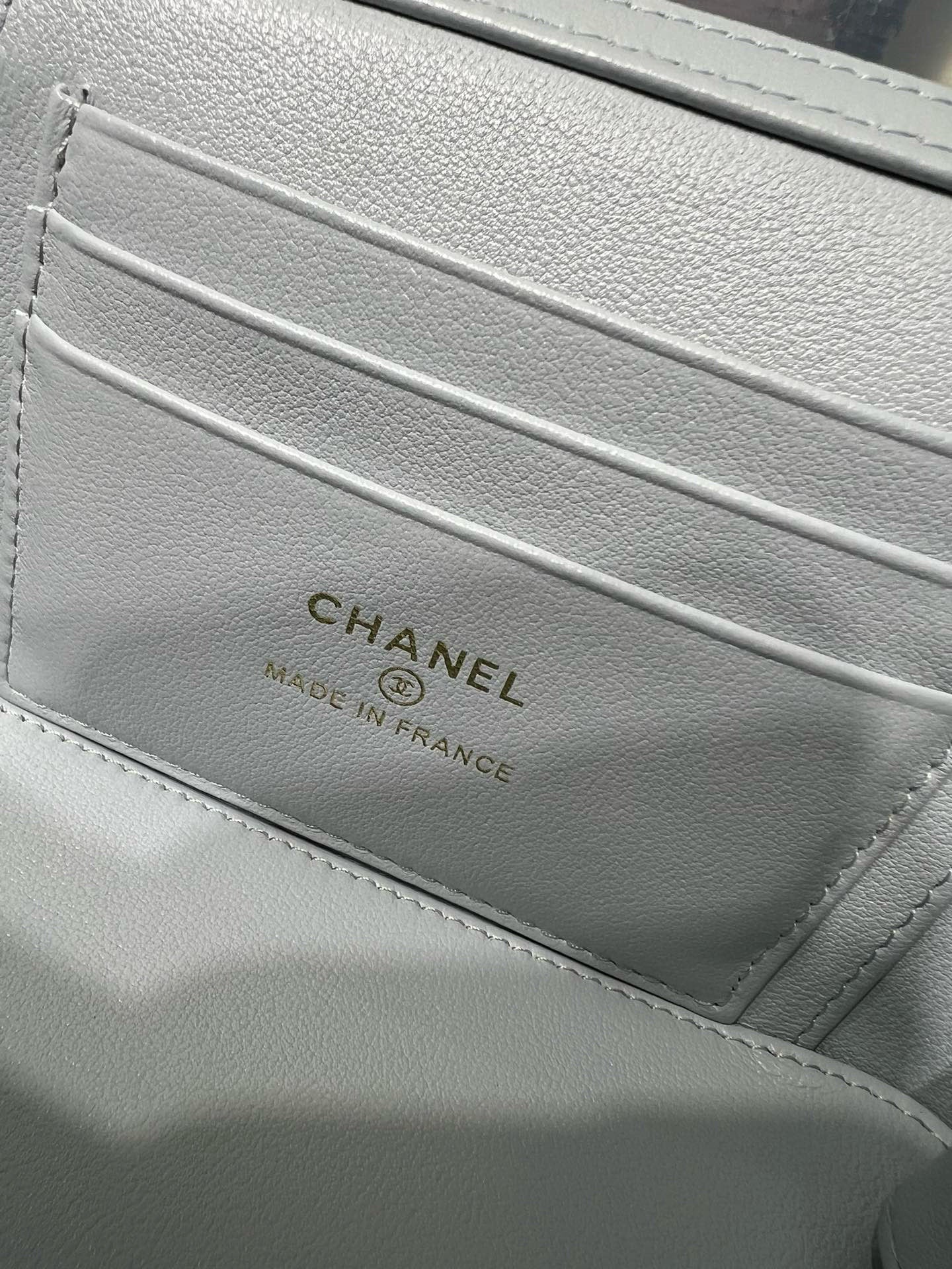 Light blue Chanel bag inside pocket with 'CHANEL' and 'Made in France' text