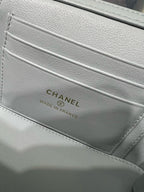 Light blue interior logo label reading CHANEL on quilted bag lining