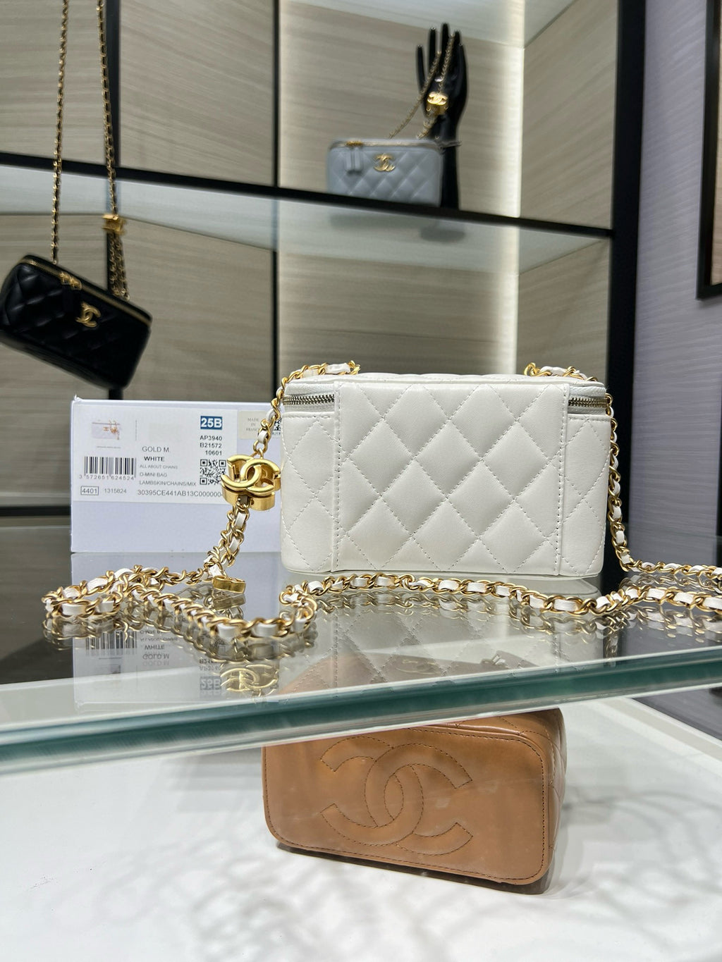 White quilted small shoulder bag with gold-tone chain strap and front flap closure