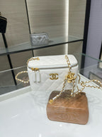 White quilted crossbody bag with gold-tone chain strap and zip-top closure