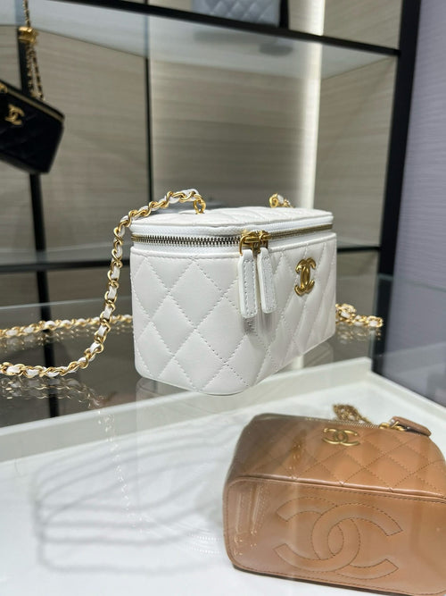White quilted mini crossbody bag with gold zipper pull and chain strap