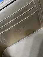 Close-up of bag interior lining with embossed Chanel name and monogram on tan leather