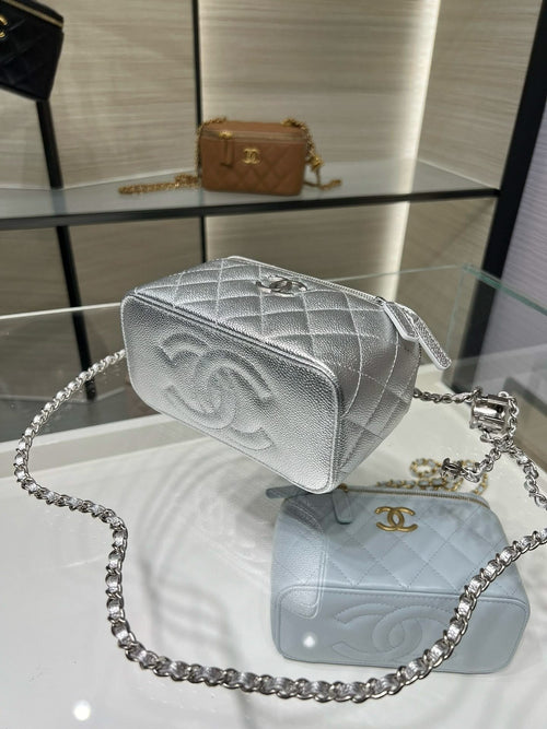 Chanel mini shoulder bag, silver-tone quilted with chain strap and CC logo.