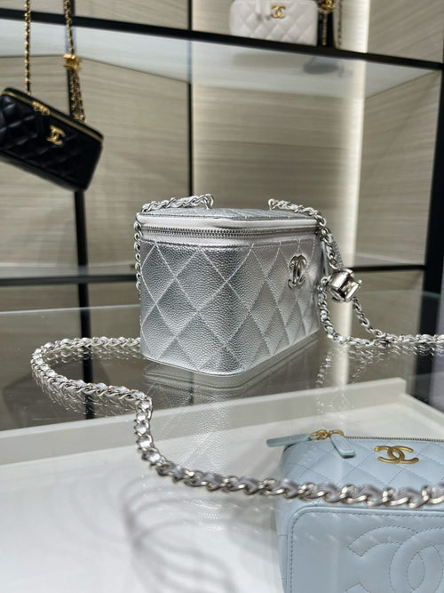 Chanel quilted mini crossbody bag, silver-tone with chain strap and top zipper.