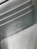 Chanel embossed logo on silver leather interior panel with stitched edge