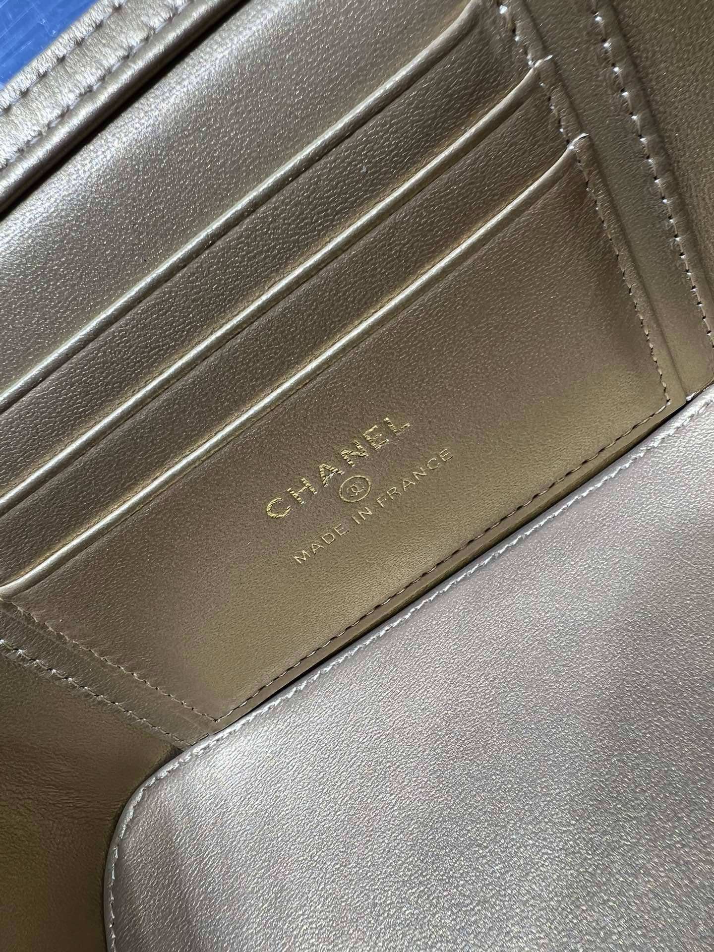 Chanel leather card holder with embossed text and stitched panel detail
