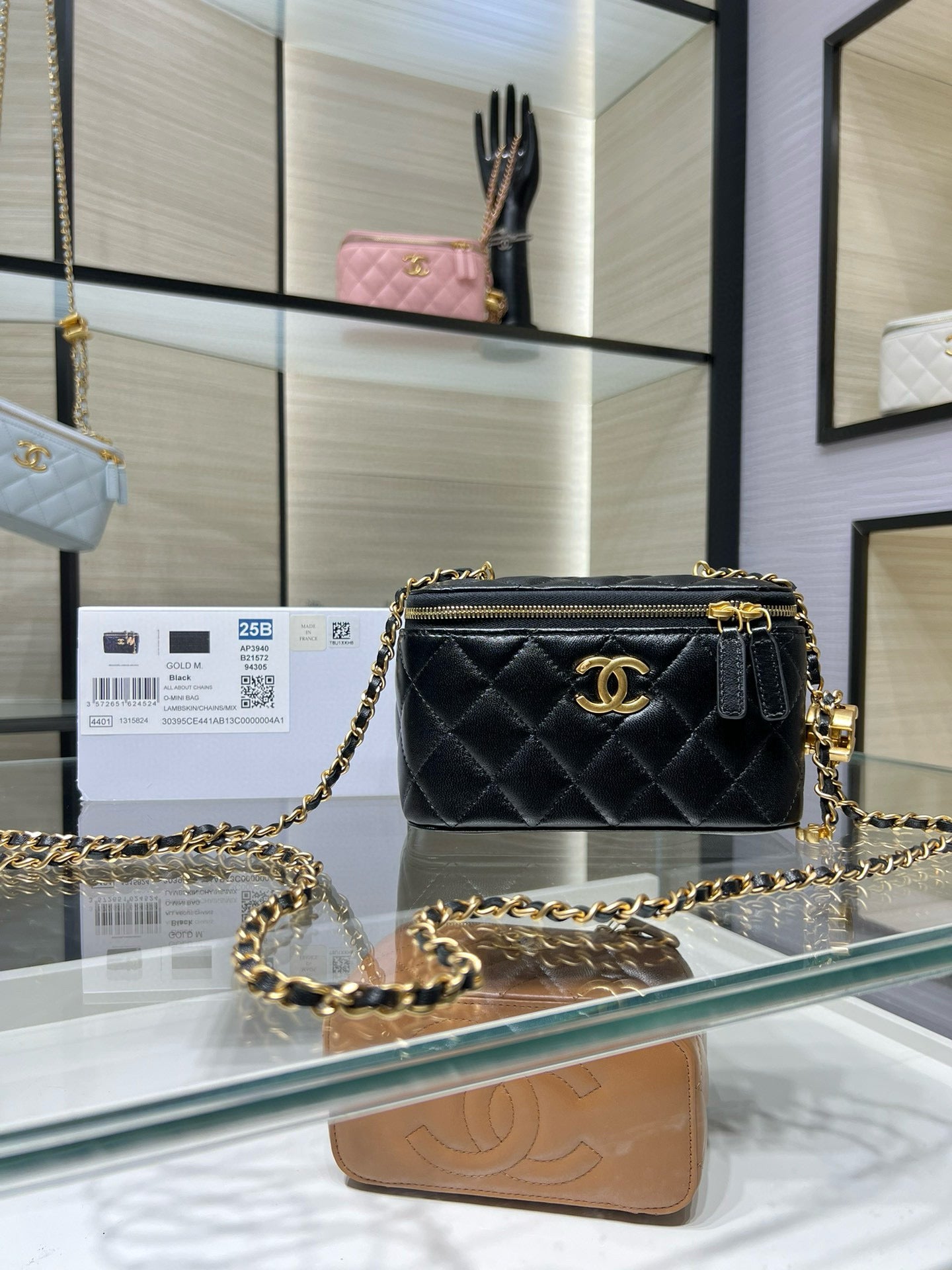Chanel quilted mini bag with gold chain, front flap, and CC logo on dark leather