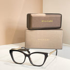 Bvlgari eyeglasses with dark rectangular frame and clear lenses, gold hinge detail