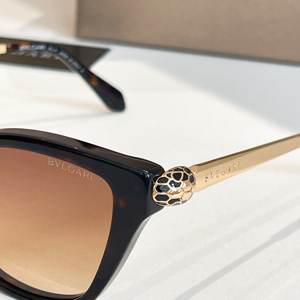 Bvlgari eyeglass frame close-up with gold crest hinge and beige-tinted lens