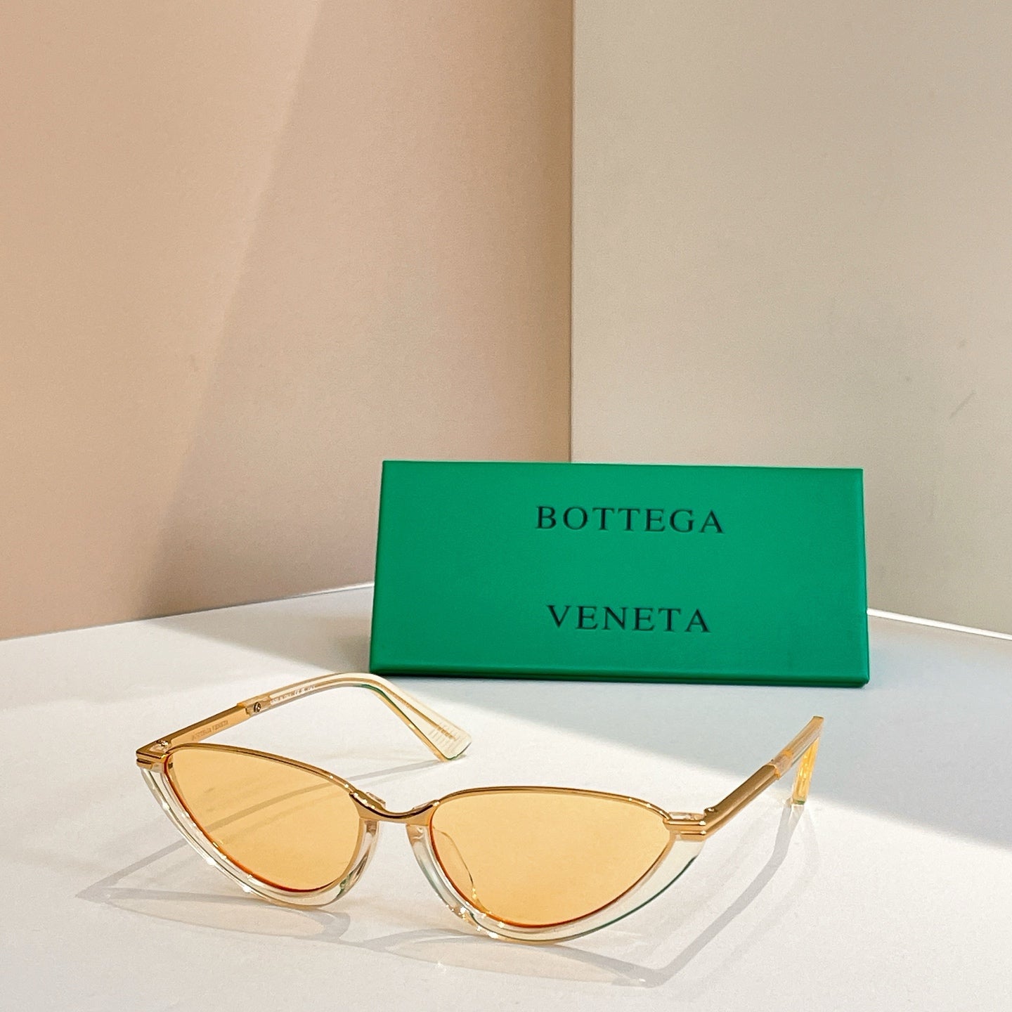 Bottega Veneta cat-eye sunglasses with amber lenses and light translucent frames