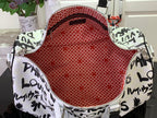 Louis Vuitton duffel bag interior with red lining and white zipper trim