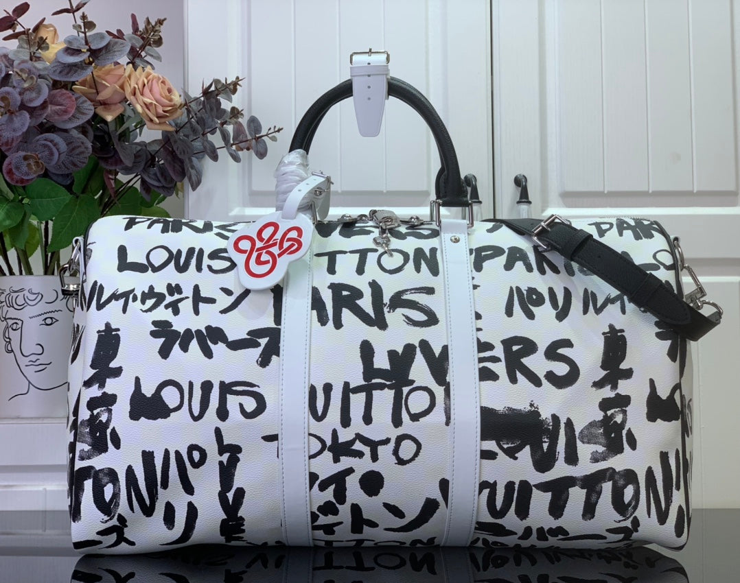 Louis Vuitton printed duffel bag with black handles and graffiti-style logo print
