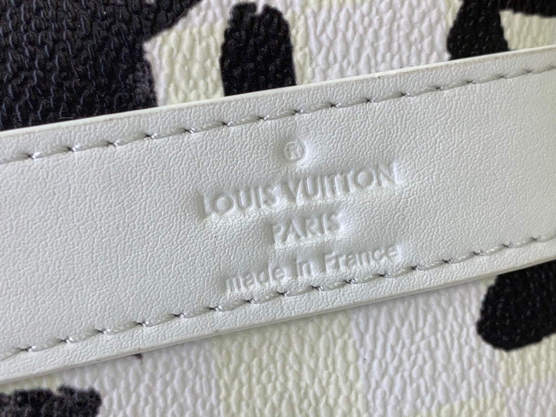 Louis Vuitton Paris made in France leather label embossed on white fabric