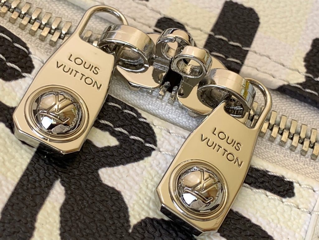 Louis Vuitton duffel bag clasp hardware in gold tone on textured leather strap