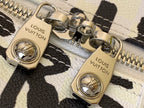 Louis Vuitton duffel bag clasp hardware in gold tone on textured leather strap