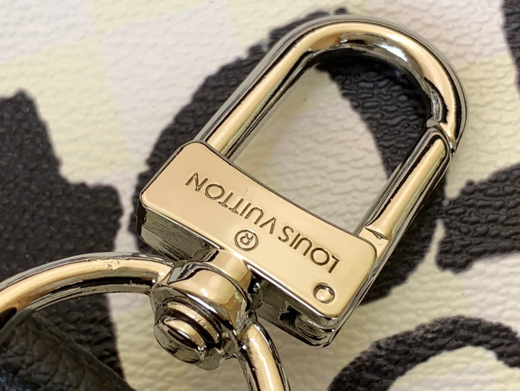 Louis Vuitton duffel bag keyring and clasp hardware, gold tone on textured leather