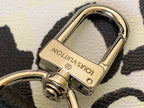 Louis Vuitton duffel bag keyring and clasp hardware, gold tone on textured leather