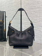 Black quilted hobo shoulder bag with top handles, snap detail, and gold hardware