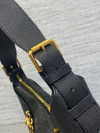 Black leather bag strap with gold buckle and matching zipper pull hardware