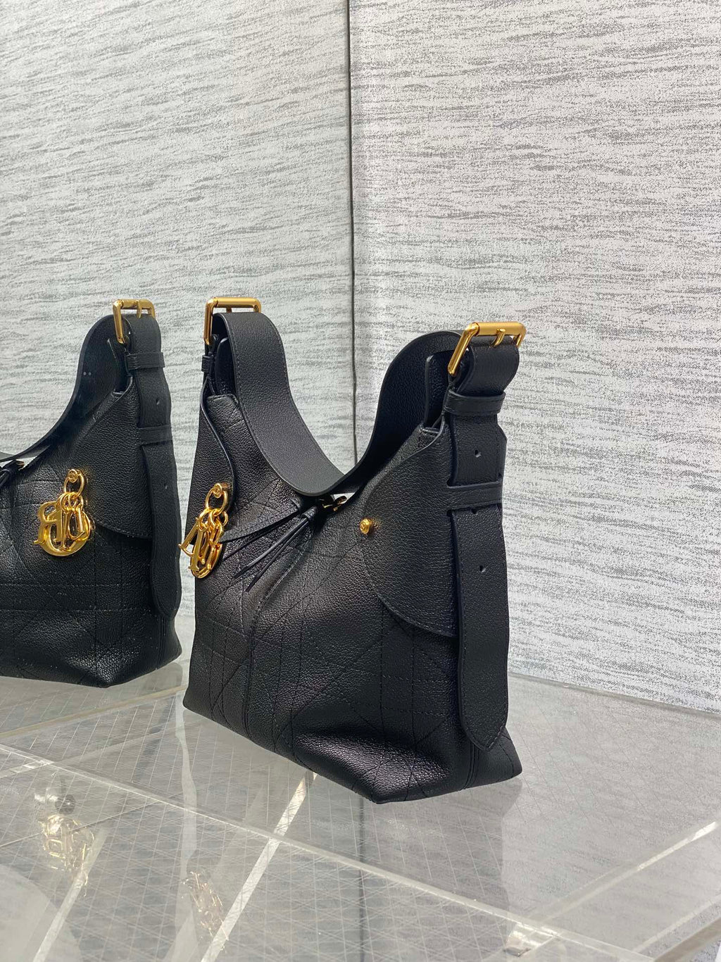 Set of three black leather quilted shoulder bags with gold-tone hardware