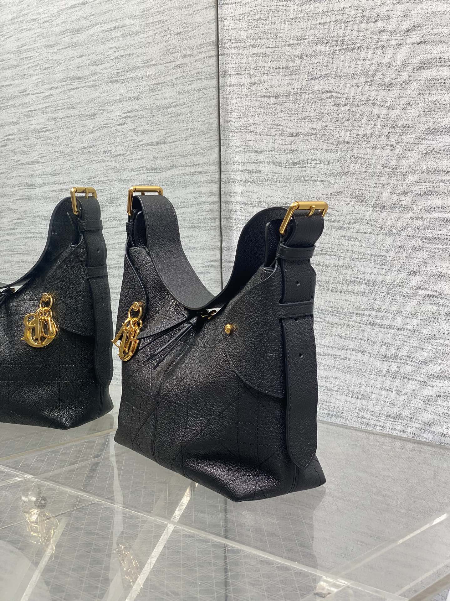Set of three black leather quilted shoulder bags with gold-tone hardware
