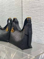 Dior quilted hobo bag with gold charm and shoulder straps, dark