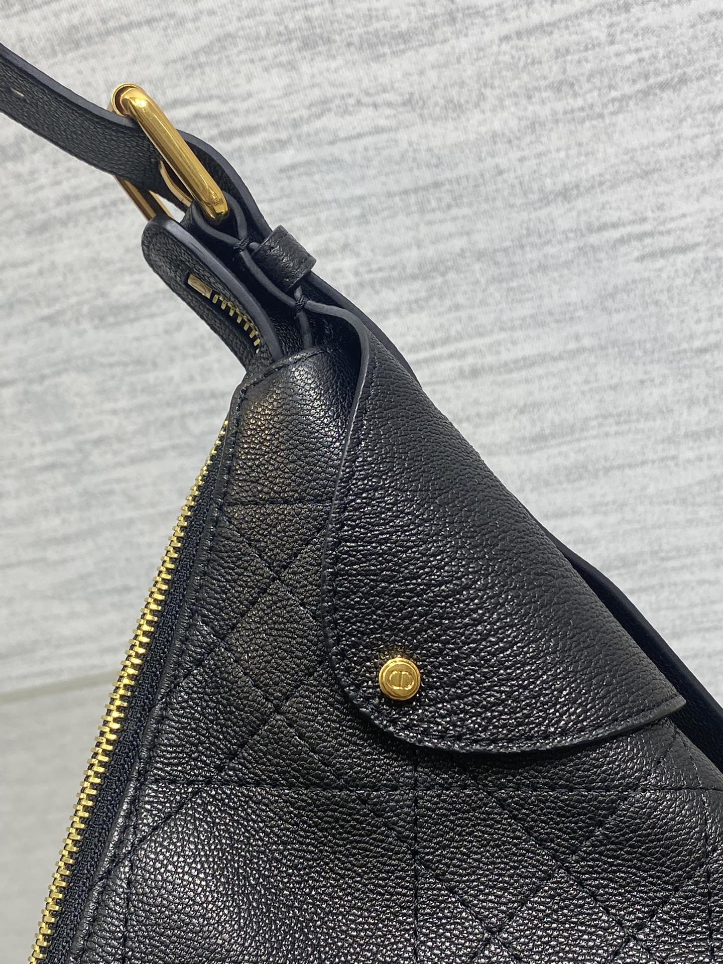 Dior quilted leather side with gold zipper pull and snap, dark
