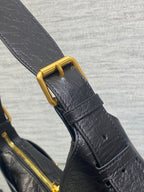 Black leather shoulder strap with gold buckle and secured snap tab