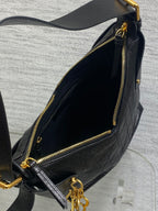 Black leather shoulder bag interior with gold zipper and gold-trim opening