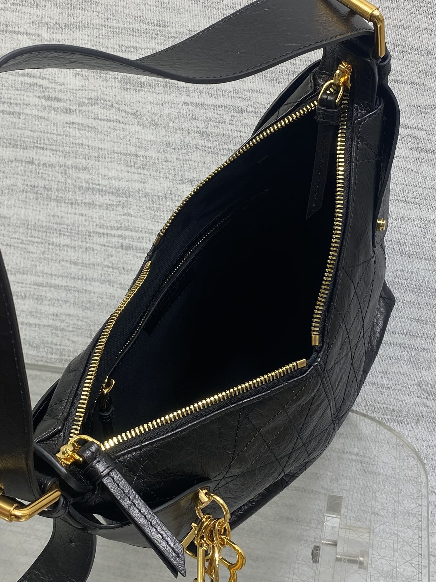 Black leather shoulder bag interior with gold zipper and gold-trim opening